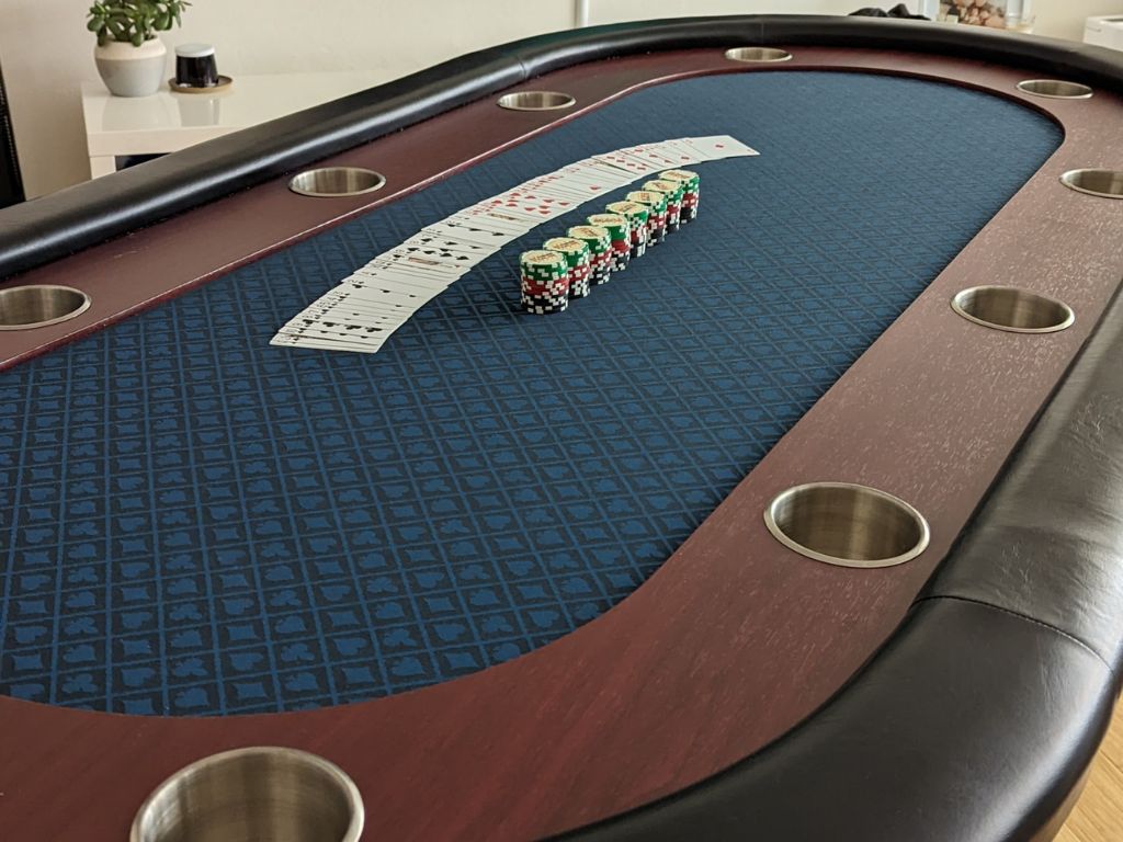 Premium Poker Table Hire with chips stacked and cards flared out